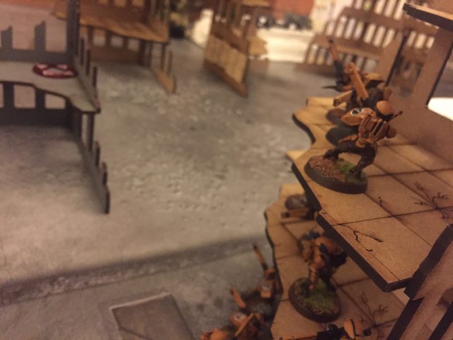 Tau Firewarriors look on as a Wyvern pounds their position from afar