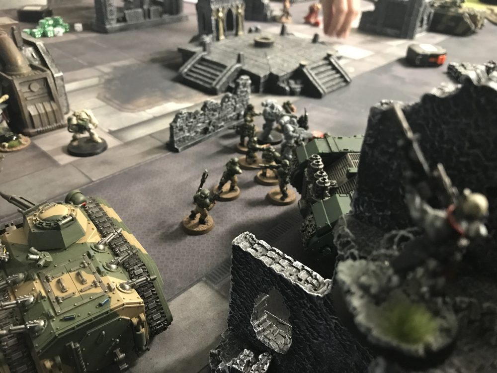 The Vindicare looks on as the Guardsmen are slaughtered - Astra Militarum vs Dark Angels